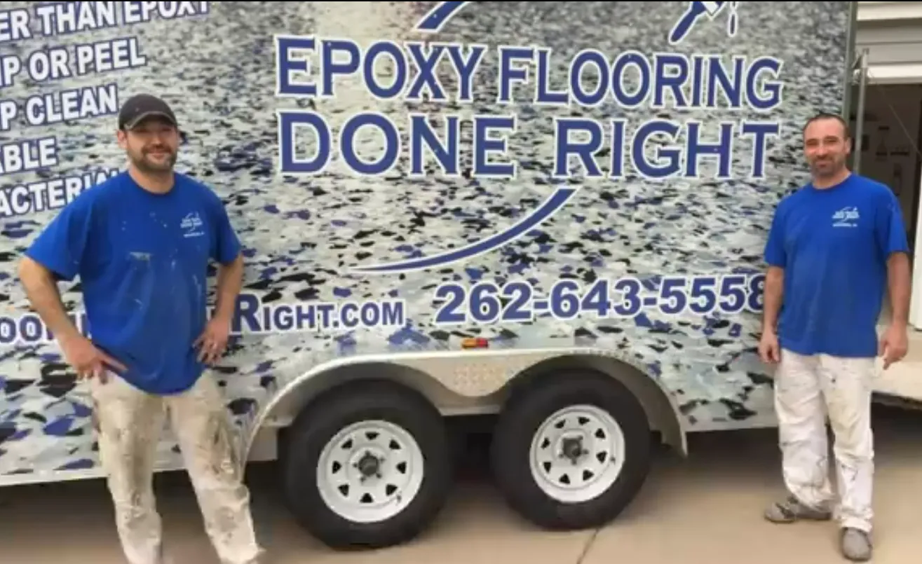 Sean and his crew member standing in front of a work trailer